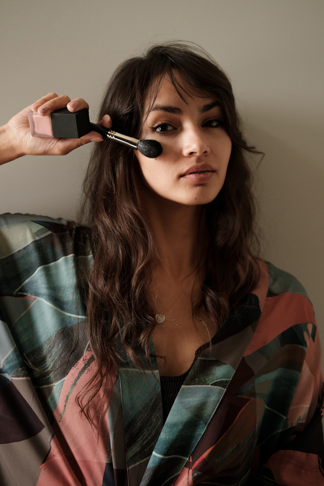 Influencer with Make-up Brush on Face 